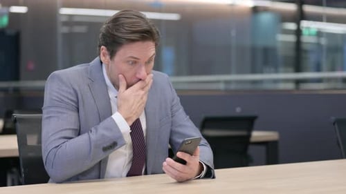 Businessman Reacts to Bad News on Smartphone