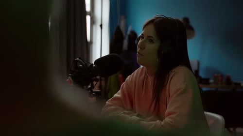 Woman Speaking into Microphone at Home Broadcast