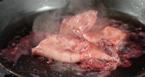 Seafood Sizzling in Frying Pan Close Up