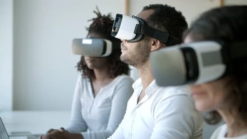 Focused People with VR Headsets Sitting at Office