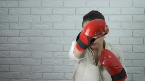 Woman Practices Boxing Punches Indoors