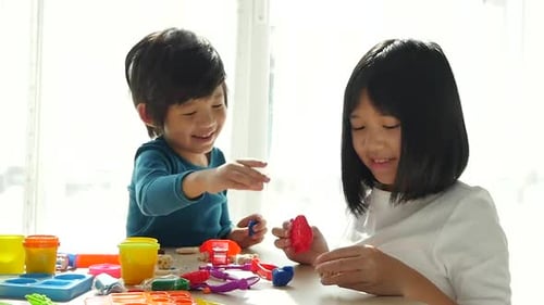 Boy and Girl Creatively Playing With Clay