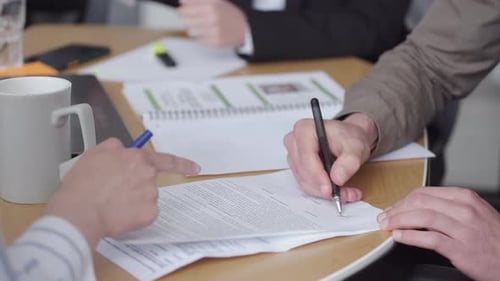 The Papers Are on the Office Table Being Signed By Male Hands