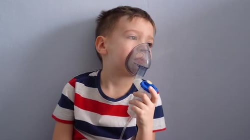 Boy Using Nebulizer Mask for Respiratory Treatment