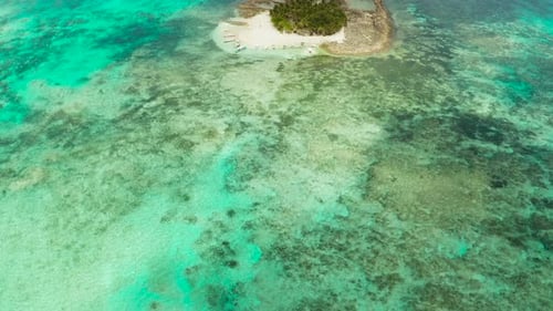 Tropical Guyam Island with a Sandy Beach and Tourists