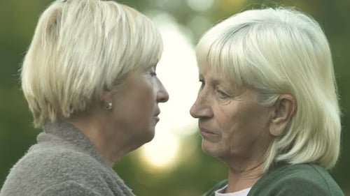 Senior Women Embrace in Green Nature Setting