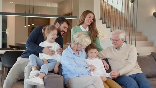 Happy Multigenerational Family Poses Together on Couch