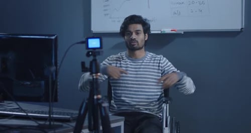 Young Adult Sits in Wheelchair and Records Video