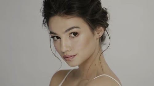 Elegant Brunette Woman Smiling in Studio Close Up