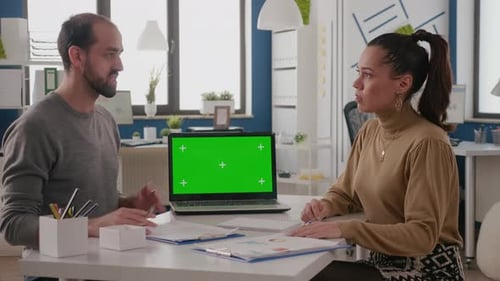 Colleagues Working with Green Screen on Laptop on Desk