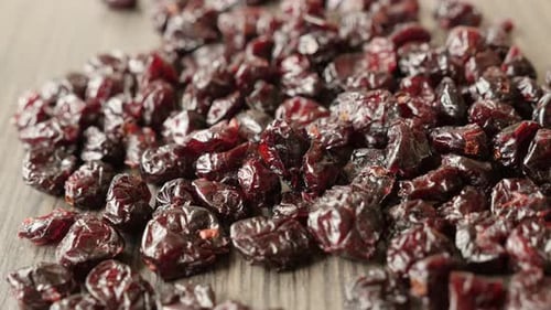 Close-up of sweet dehydrated cranberries on pile 4K 2160p 30fps UltraHD tilting footage - Heap of or