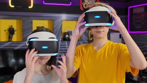 Teenagers Removing Virtual Reality Headsets