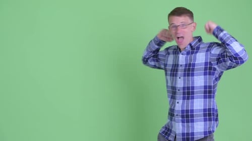 Man Cheering and Smiling on Green Background
