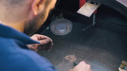 Goldsmith Makes Chain with Little Links Above Table Closeup