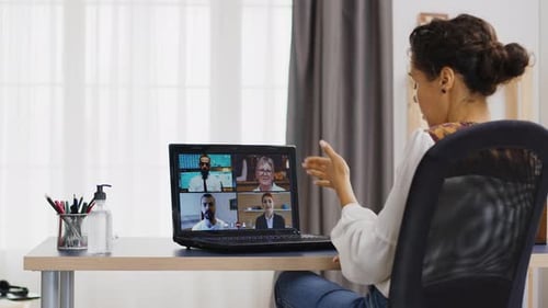Woman Attends Virtual Meeting From Home Office