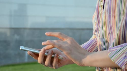 Close Up Female Hands Holding Smartphone and Browsing Website