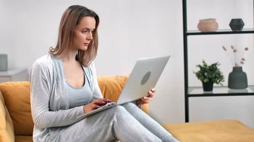 Woman Works on Laptop in Modern Living Room