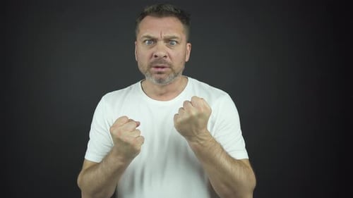 Adult Man Clenches Fists in Intense Anger