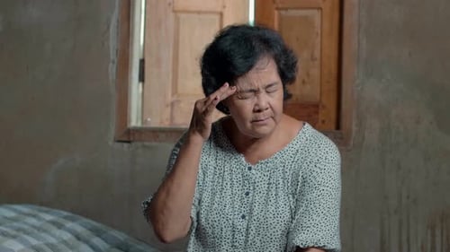Asian Senior Woman Have A Headache