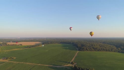 Aerial View of Hot Air Balloons Over Countryside