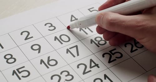 Red Marker Crossing Out Date on Calendar