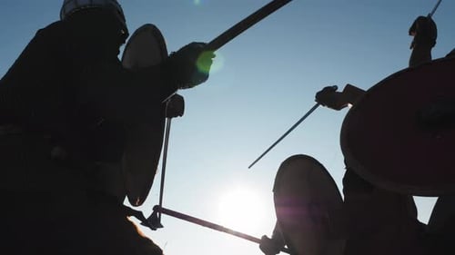 Silhouetted Warriors Fighting with Swords and Shields