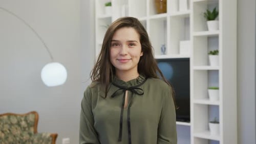 Young Woman Smiling at Camera Indoors
