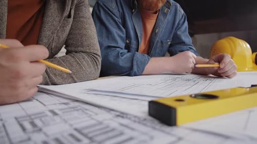 Close Up of Architects Working on Floor Plan