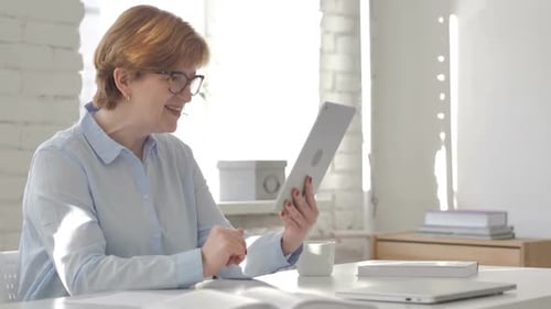 Adult Woman Using Tablet for Video Call at Home