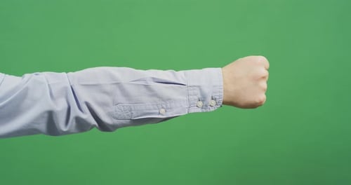 Isolated Arm Clenched Fist Over Green Screen