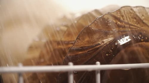 Water Washing Plates in a Dish Rack