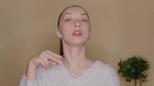 Woman Demonstrating Face Massage Routine