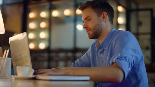 Business Man Typing on Laptop in Office