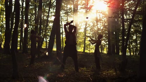 Contre jour of persons spinning fire umbrellas, Ultra Slow Motion