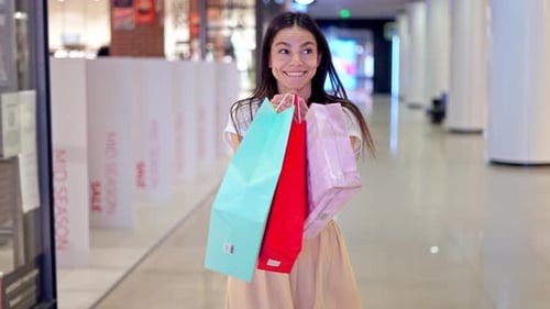 Happy Woman Jumping in Excitement in Shopping Mall