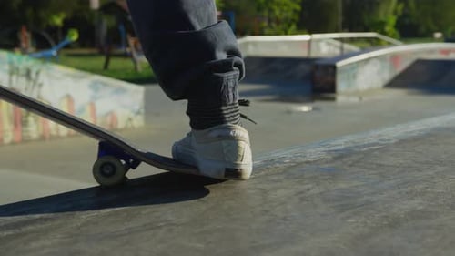 Skateboarder Does Tricks at Skate Park