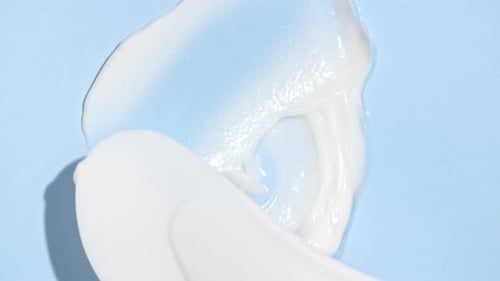 White Creamy Texture Spreads on Blue Surface