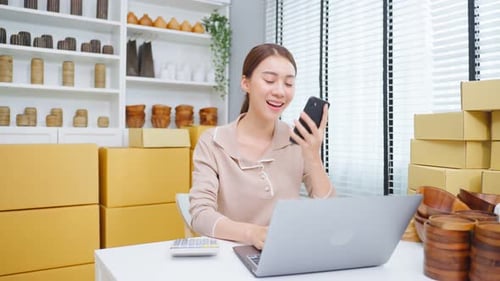 Asian beautiful woman talk on mobile phone call with customer at store.