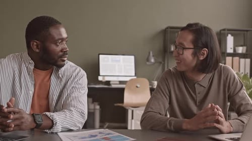 Two Diverse Men Working in Team at Office
