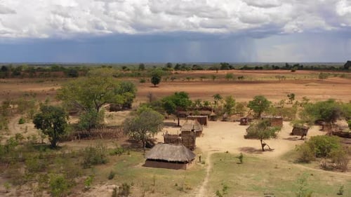A remote African village with homes made from mud and grass. Zambia, Africa. 4K