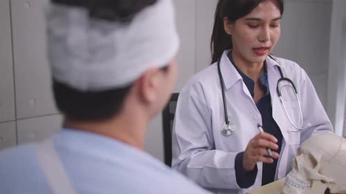 Doctor Explains Head Injury Using Skull to Patient