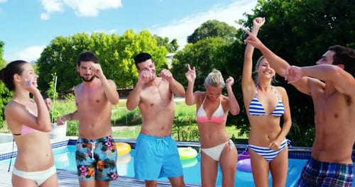 Group of Friends Dancing by the Swimming Pool
