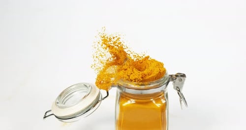 Turmeric, curcuma longa, Powder against White Background, Indian Spice, Slow Motion 4K