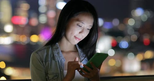 Woman use of mobile phone at night