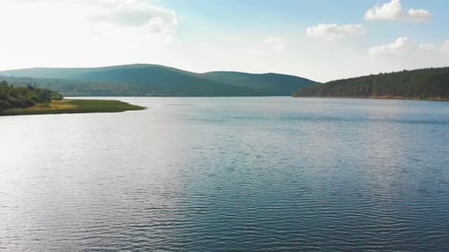 Landscape of Nature - Blue Clear River Between the Forest and Hills Afar