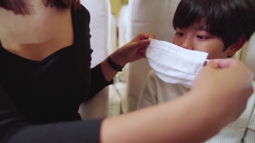 Traveler Wearing Face Mask While Traveling on Commercial Airplane