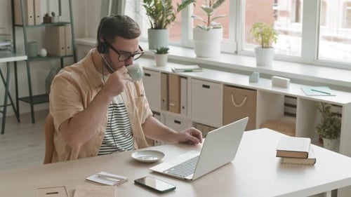 Young Adult Working At Home Office On Laptop