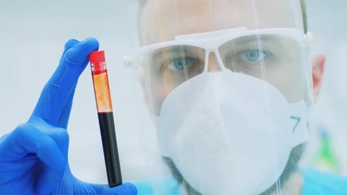 Medical Professional Holds Blood Sample for Analysis