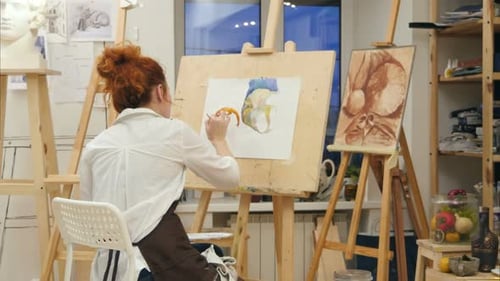 Woman Artist Painting Watercolor Picture in Her Studio