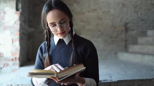 Young Woman Studies, Reads Book in Historical Setting
